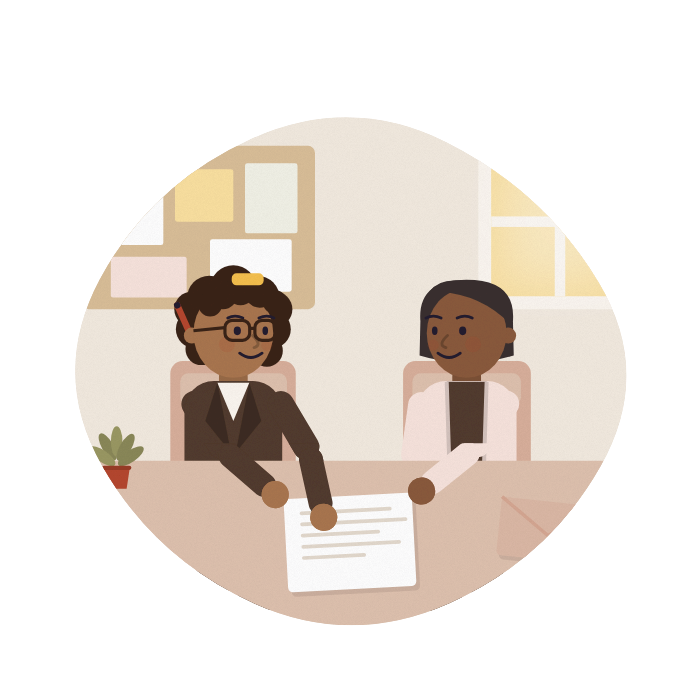 An adviser and a carer talk across a desk at a community centre, both looking at the same letter.