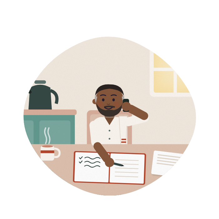 A man makes a phone call at his kitchen table, writing notes in a notebook beside a letter.