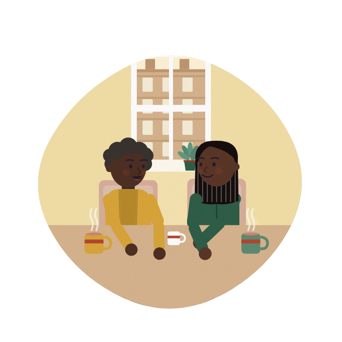 A mother and daughter talk over tea at the kitchen table, heads close together.