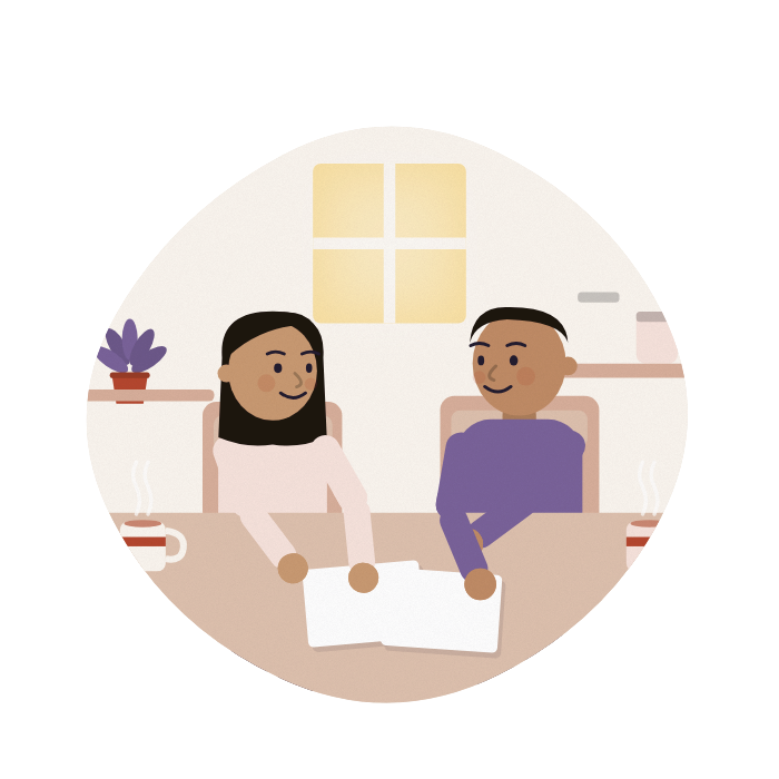 A brother and sister talk things over at a kitchen table with tea.