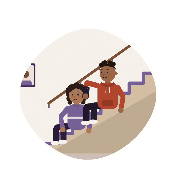 A brother and sister sit on the stairs, sharing a plan on a phone.