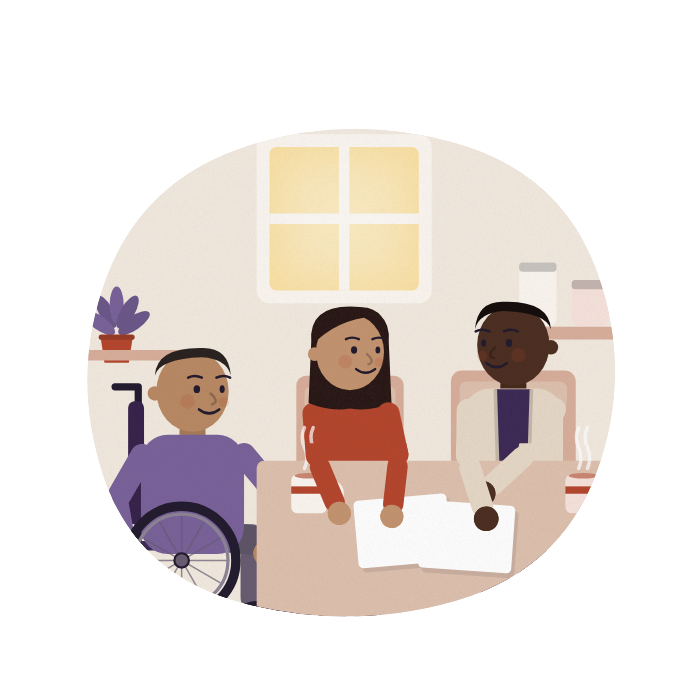 A nurse and a family sit round a kitchen table, talking through some papers.