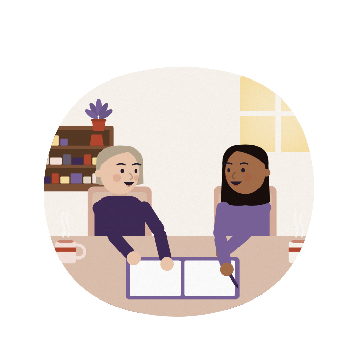 A woman and her care coordinator agree a plan, both smiling.