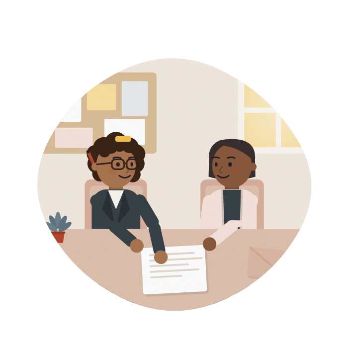 An adviser and a carer talk across a desk at a community centre, both looking at the same letter.