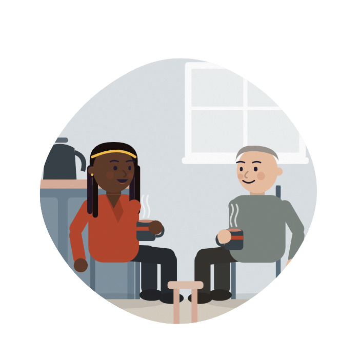 A worker and her manager talk over coffee in a quiet staff room.
